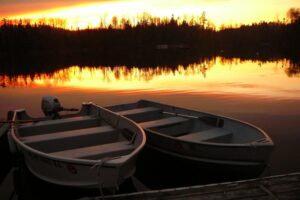 Two motorboats docked during the sunset