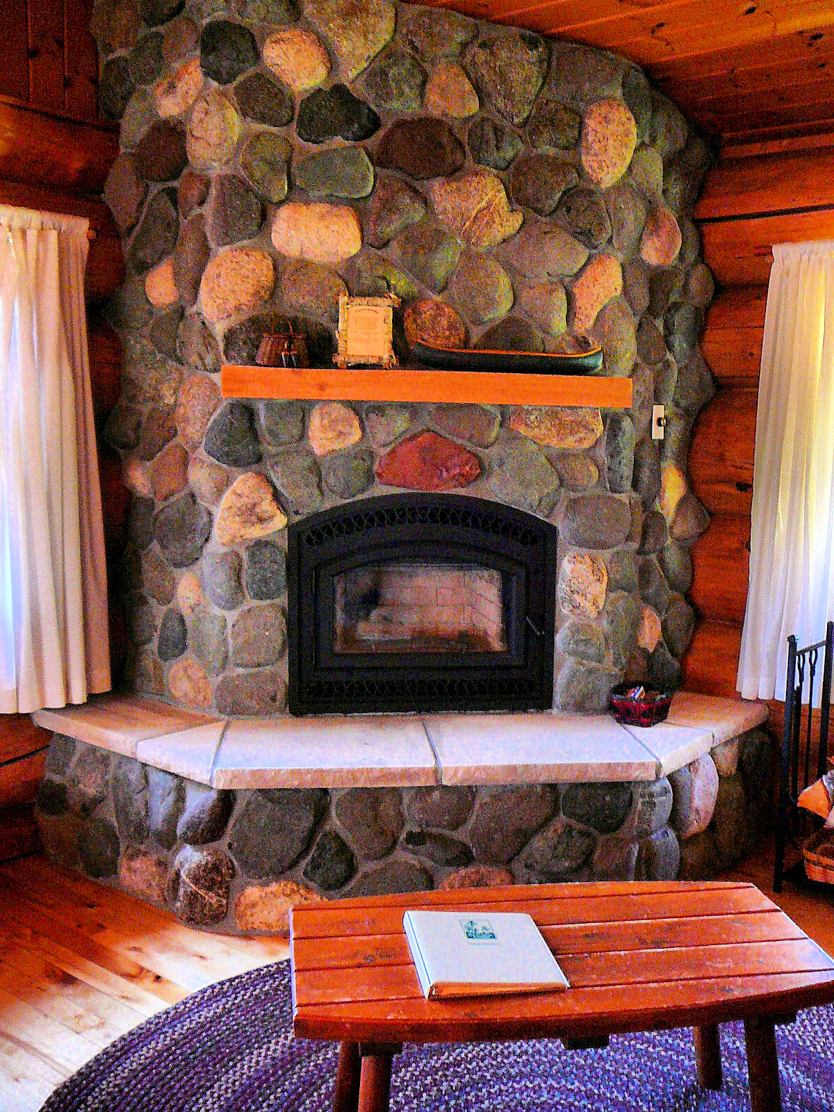 Close up of stone fireplace in a log cabin