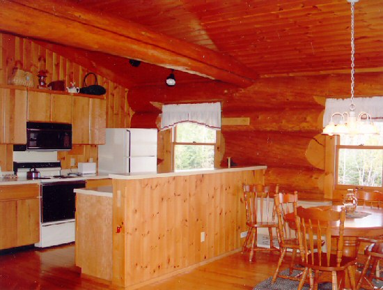 Kitchen area of a log cabin with circle dining table